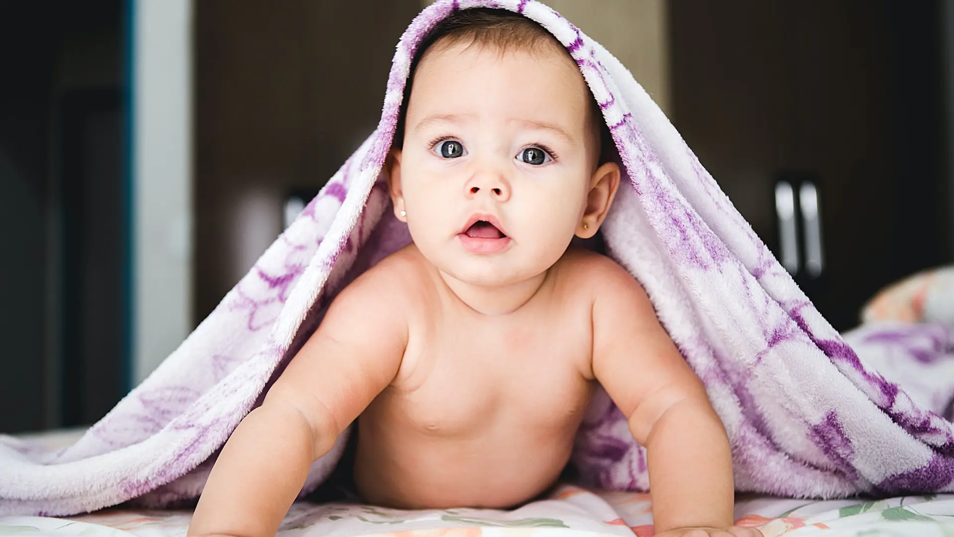 baby under purple blanket